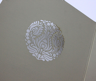 Light brown wedding invitation card with laser cut motif